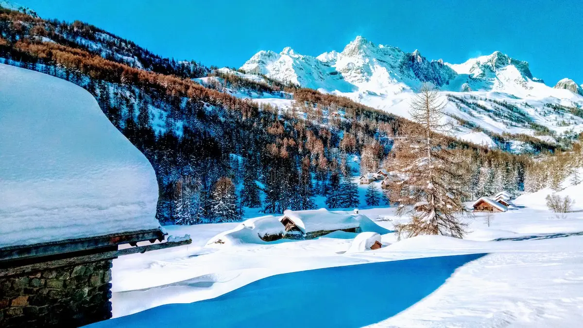 Guided snowshoe group on a panoramic ridge in Montgenèvre, French–Italian Alps